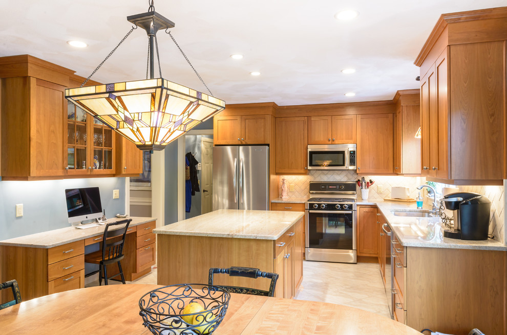 Example of a large arts and crafts l-shaped marble floor and white floor eat-in kitchen design in Boston with an undermount sink, shaker cabinets, medium tone wood cabinets, granite countertops, beige backsplash, subway tile backsplash, stainless steel appliances and an island