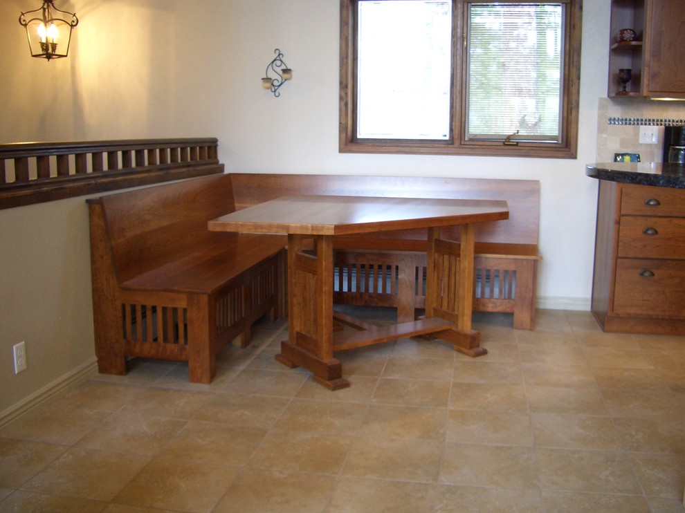 Exempel på ett stort amerikanskt grå grått kök, med en undermonterad diskho, skåp i shakerstil, skåp i mellenmörkt trä, granitbänkskiva, beige stänkskydd, stänkskydd i stenkakel, svarta vitvaror, travertin golv, en köksö och beiget golv