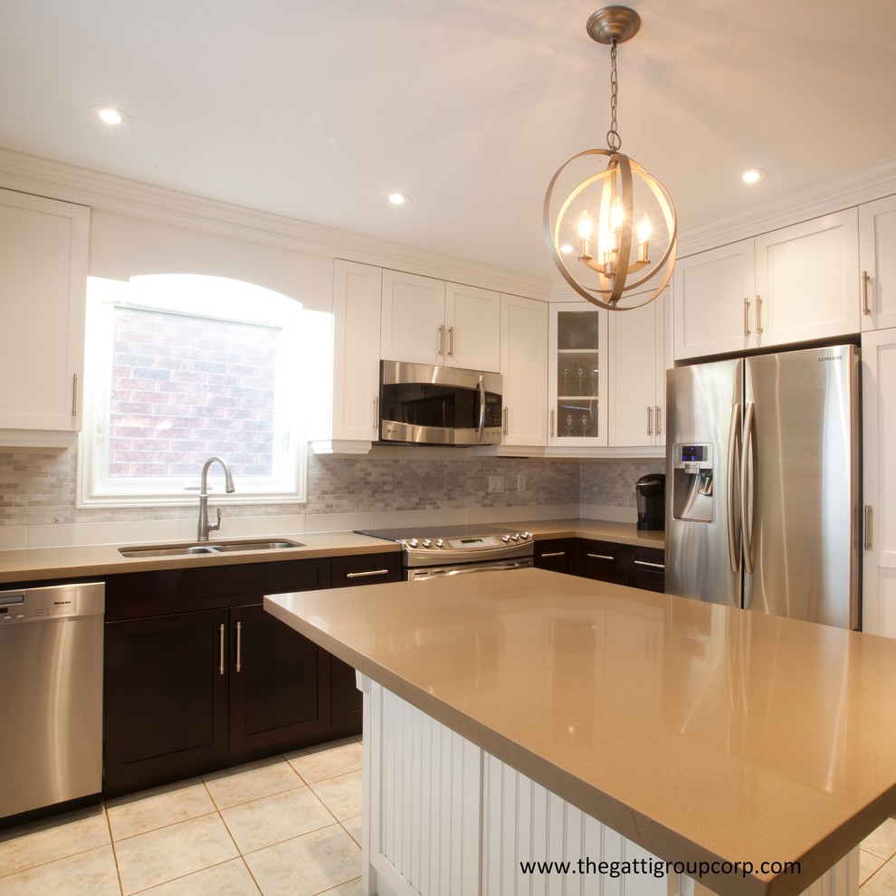 This is an example of a contemporary l-shaped enclosed kitchen in Toronto with a submerged sink, shaker cabinets, engineered stone countertops, white splashback and stainless steel appliances.