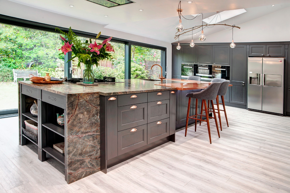Photo of a large traditional kitchen in Other with shaker cabinets, dark wood cabinets, granite worktops and an island.
