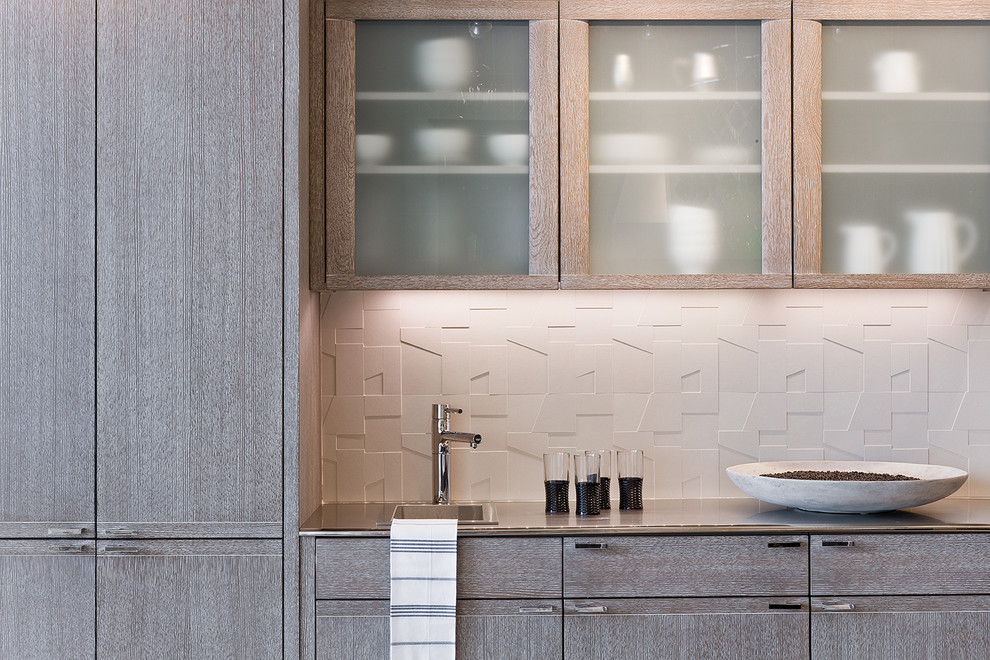 Inspiration for a contemporary kitchen remodel in Boston with glass-front cabinets, light wood cabinets, white backsplash and porcelain backsplash