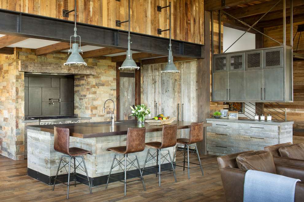 Design ideas for a rustic open plan kitchen in Denver with brown splashback, stainless steel appliances, medium hardwood flooring, an island, brown floors and brown worktops.