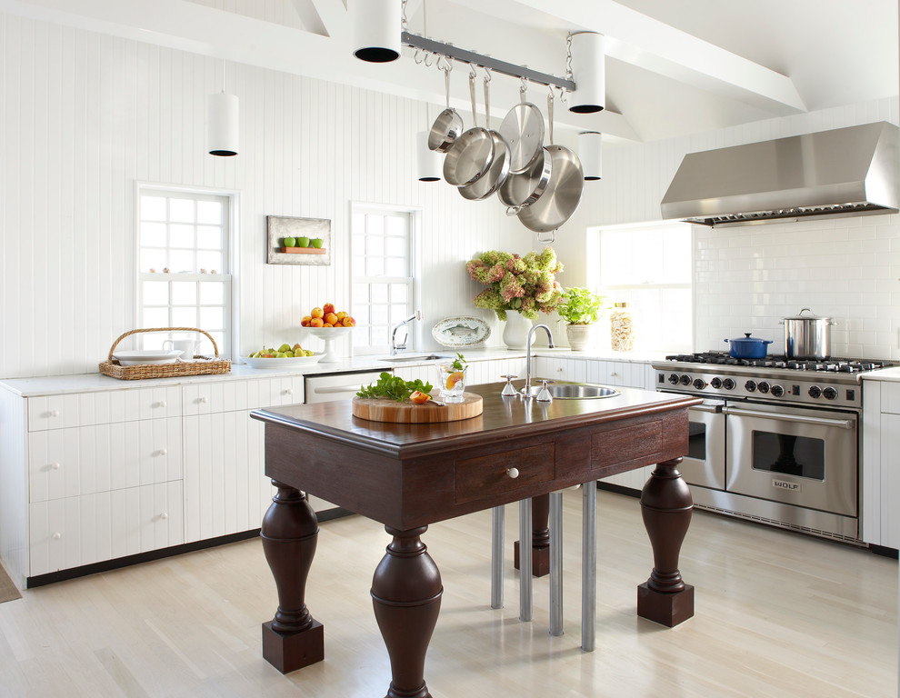Inspiration for a timeless l-shaped light wood floor kitchen remodel in Boston with white cabinets, marble countertops, white backsplash, stainless steel appliances, an island, a single-bowl sink and subway tile backsplash
