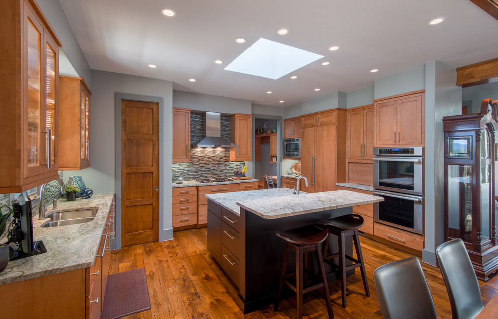 Inspiration for a transitional u-shaped dark wood floor kitchen remodel in Other with recessed-panel cabinets, light wood cabinets, granite countertops, paneled appliances and an island