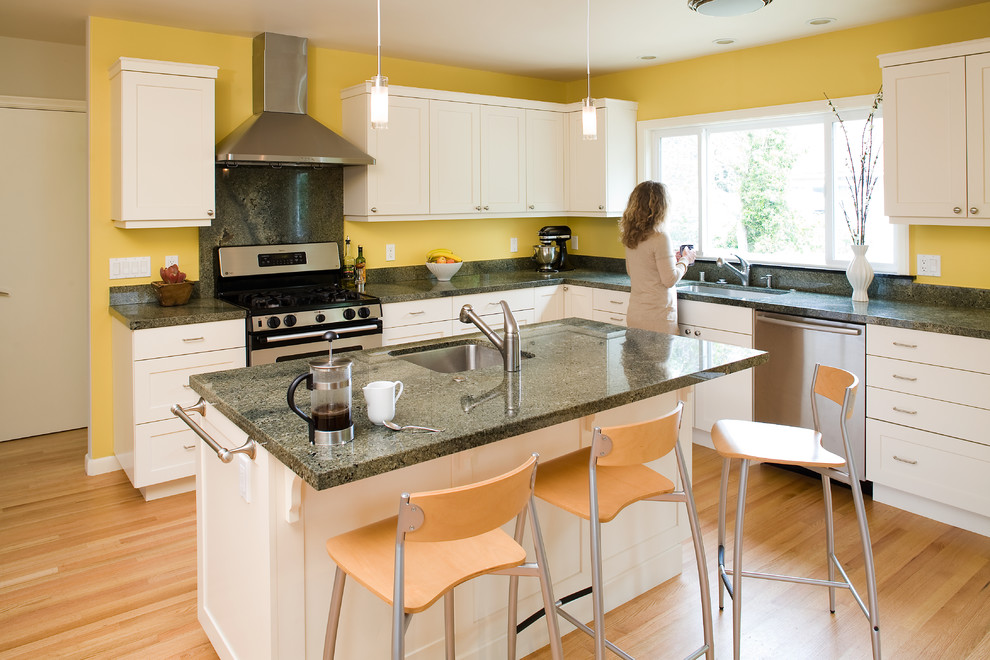 Contemporary kitchen in San Francisco with white cabinets and green worktops.