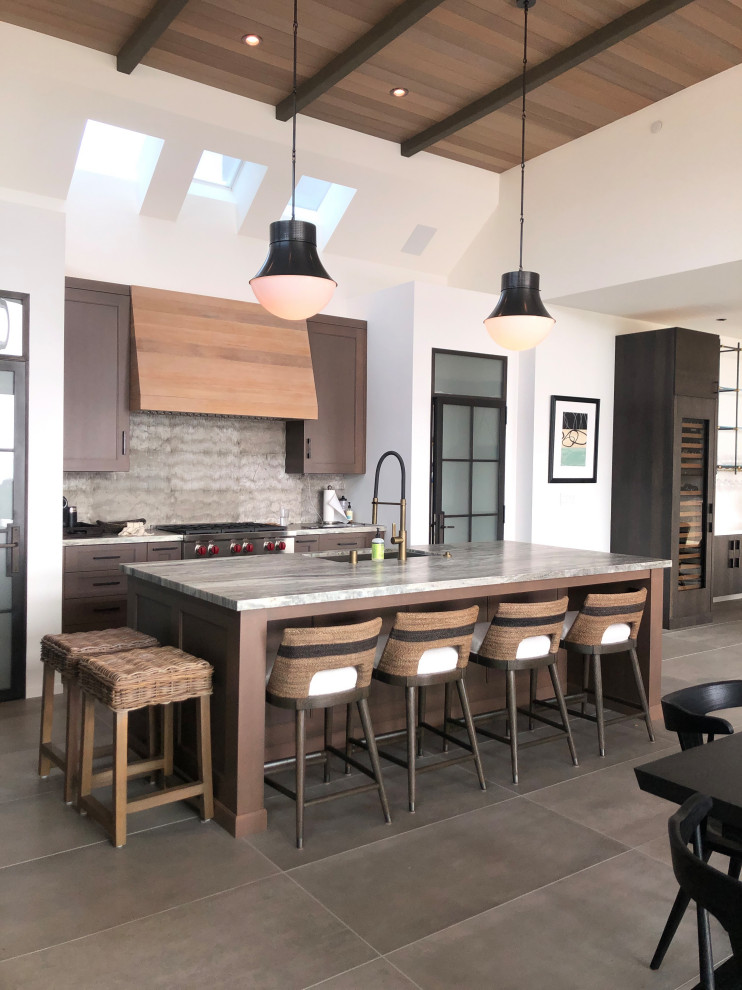 This is an example of a contemporary galley kitchen in San Francisco with a submerged sink, shaker cabinets, dark wood cabinets, grey splashback, stainless steel appliances, an island, grey floors, grey worktops, exposed beams and a wood ceiling.
