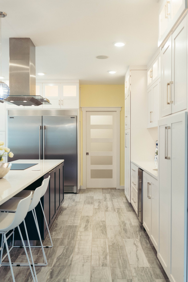 Exempel på ett stort modernt vit vitt kök, med en rustik diskho, skåp i shakerstil, gula skåp, bänkskiva i kvarts, blått stänkskydd, stänkskydd i glaskakel, rostfria vitvaror, klinkergolv i porslin, en köksö och grått golv