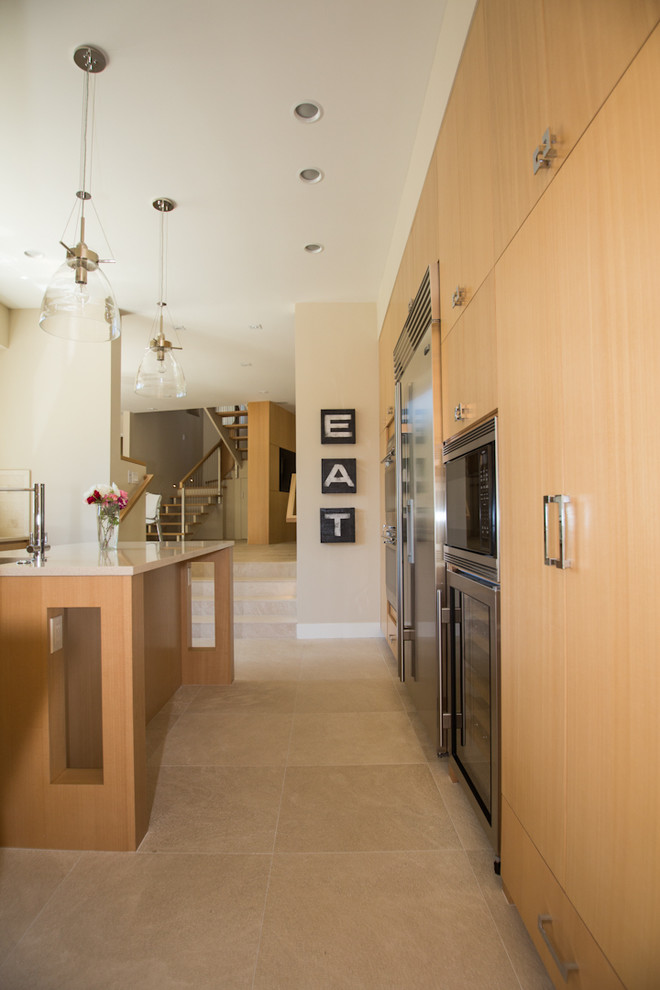 Foto di una cucina minimalista di medie dimensioni con lavello sottopiano, ante lisce, ante in legno chiaro, top in quarzite, paraspruzzi beige, paraspruzzi in legno, elettrodomestici in acciaio inossidabile, pavimento in gres porcellanato e pavimento beige