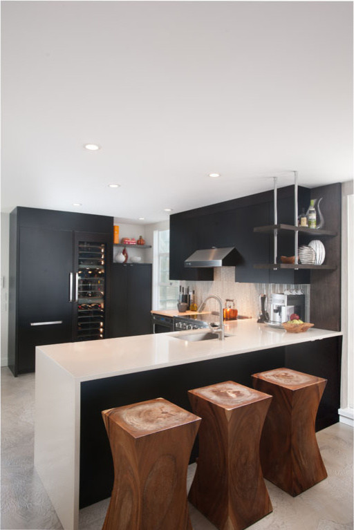 Inspiration for a modern u-shaped open concept kitchen remodel in Vancouver with an undermount sink, flat-panel cabinets, black cabinets, quartz countertops, white backsplash, glass tile backsplash and stainless steel appliances