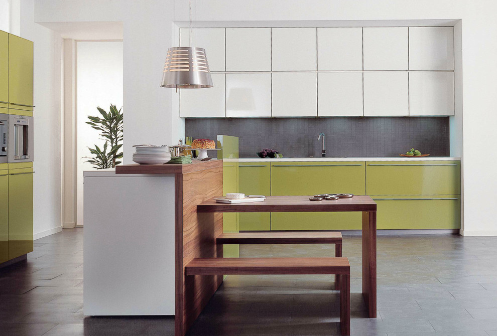 Design ideas for a medium sized modern single-wall open plan kitchen in London with a built-in sink, flat-panel cabinets, green cabinets, quartz worktops, grey splashback, mosaic tiled splashback, integrated appliances, ceramic flooring and an island.