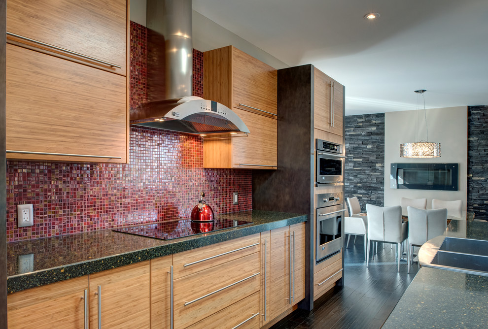 This is an example of a contemporary kitchen in Ottawa with flat-panel cabinets, red splashback, mosaic tiled splashback, medium wood cabinets and a double-bowl sink.
