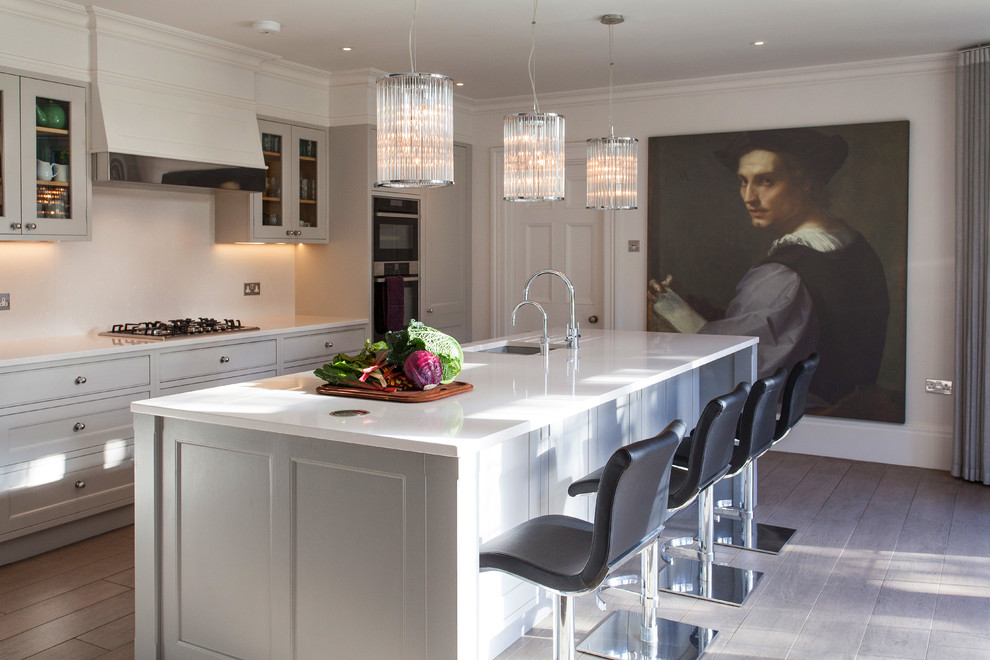 Medium sized traditional kitchen in Hampshire with a submerged sink, glass-front cabinets, grey cabinets, medium hardwood flooring and an island.
