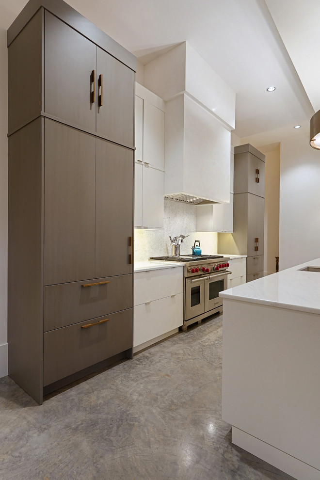 Photo of a large contemporary single-wall kitchen/diner in New Orleans with a submerged sink, flat-panel cabinets, medium wood cabinets, granite worktops, white splashback, mosaic tiled splashback, integrated appliances, concrete flooring, an island, grey floors and white worktops.
