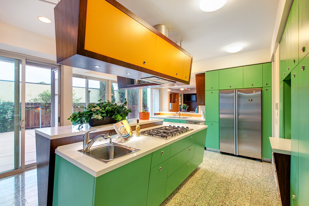 Trendy l-shaped open concept kitchen photo in San Diego with a double-bowl sink, flat-panel cabinets, quartz countertops, stainless steel appliances and an island