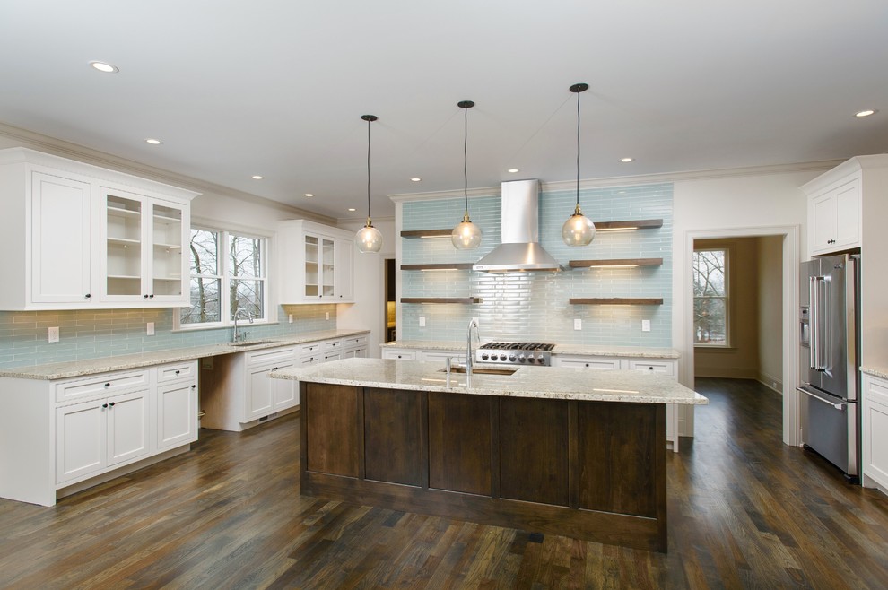 Example of a mid-sized arts and crafts dark wood floor kitchen design in Bridgeport with an undermount sink, beaded inset cabinets, white cabinets, granite countertops, glass tile backsplash, stainless steel appliances, an island and blue backsplash