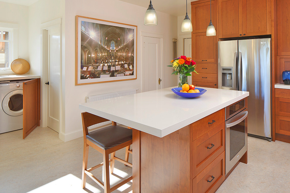 Arts and crafts u-shaped eat-in kitchen photo in San Francisco with an undermount sink, shaker cabinets, medium tone wood cabinets, quartz countertops, subway tile backsplash and stainless steel appliances