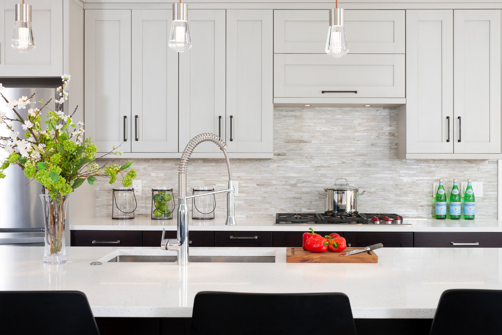 Design ideas for a large classic l-shaped open plan kitchen in DC Metro with a double-bowl sink, shaker cabinets, grey cabinets, engineered stone countertops, beige splashback, mosaic tiled splashback, stainless steel appliances, dark hardwood flooring and an island.