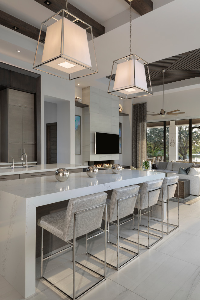 Large modern kitchen in Miami with a submerged sink, flat-panel cabinets, dark wood cabinets, integrated appliances, porcelain flooring, multiple islands, beige floors and white worktops.