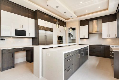 Spacious modern kitchen with two-tone RTA cabinets illustrating cost and time advantages over custom cabinetry