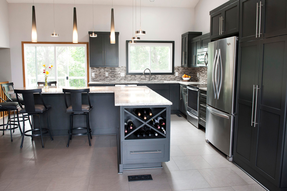 This is an example of a large modern l-shaped kitchen/diner in Other with a submerged sink, shaker cabinets, black cabinets, granite worktops, multi-coloured splashback, mosaic tiled splashback, stainless steel appliances, ceramic flooring, an island, grey floors and white worktops.