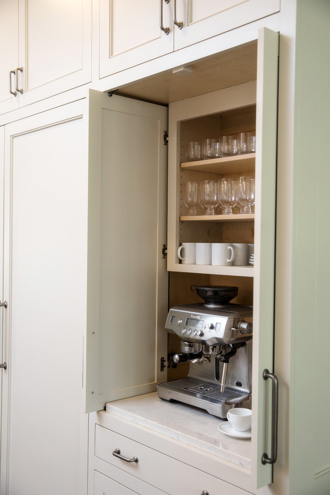 Inspiration for a classic l-shaped kitchen pantry in New Orleans with a single-bowl sink, shaker cabinets, white cabinets, engineered stone countertops, white splashback, stainless steel appliances, an island and white worktops.