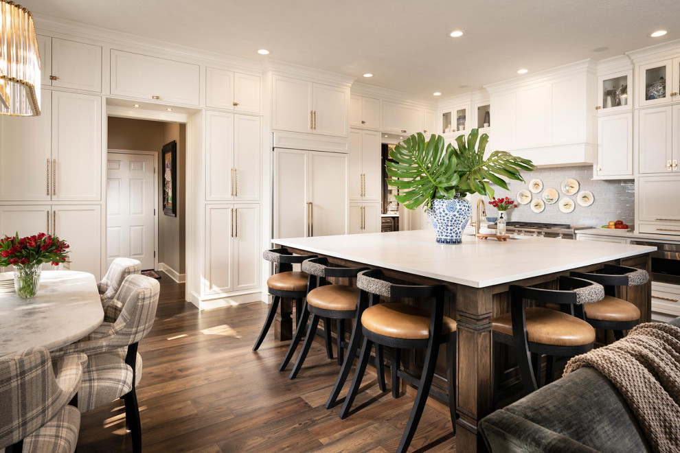 Open concept kitchen - large traditional l-shaped dark wood floor and vaulted ceiling open concept kitchen idea in Other with an undermount sink, quartz countertops, blue backsplash, subway tile backsplash, stainless steel appliances, an island and white countertops