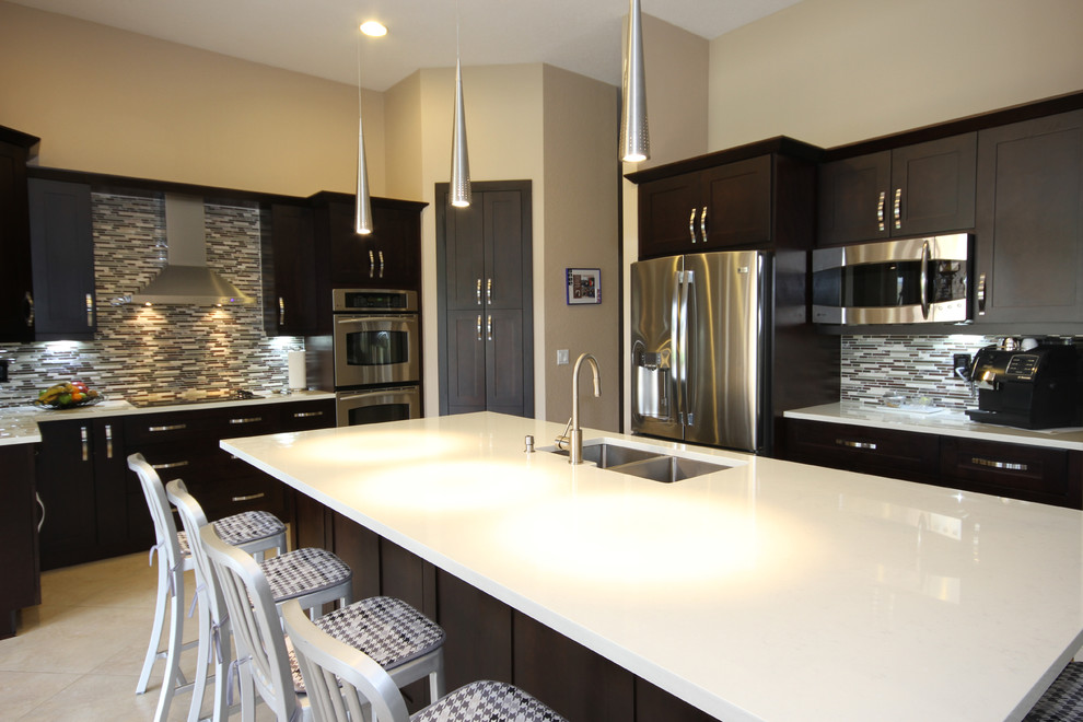 Example of a minimalist l-shaped eat-in kitchen design in Miami with an undermount sink, shaker cabinets, dark wood cabinets, quartzite countertops, multicolored backsplash and stainless steel appliances