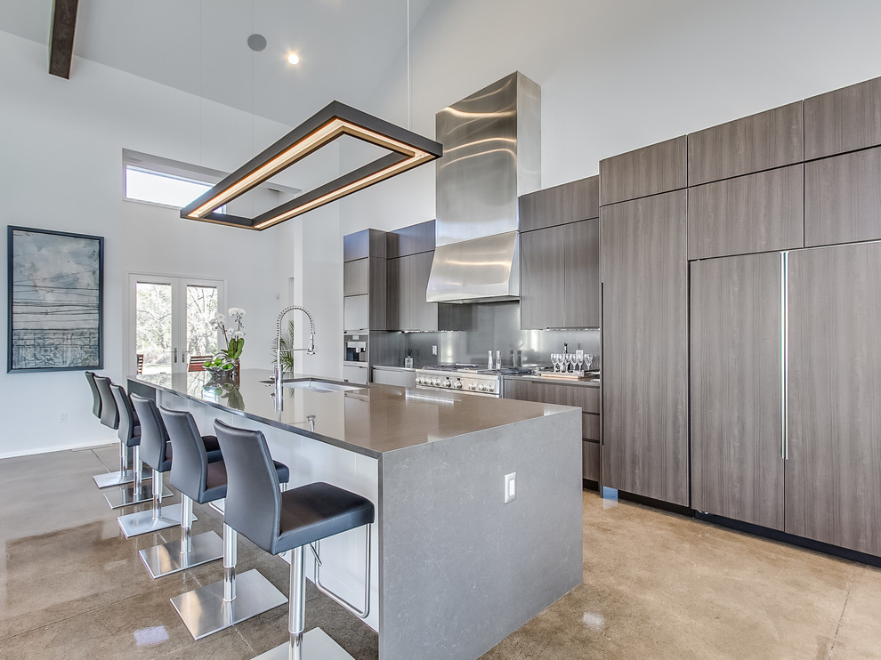 Inspiration for a contemporary kitchen in Oklahoma City with a submerged sink, flat-panel cabinets, metallic splashback, integrated appliances and an island.