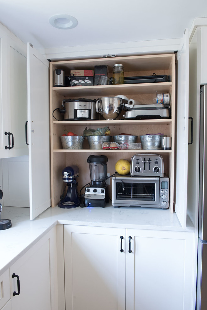 Large cottage u-shaped light wood floor and brown floor eat-in kitchen photo in Boston with shaker cabinets, white cabinets, quartz countertops, white backsplash, mosaic tile backsplash, stainless steel appliances, a peninsula and white countertops
