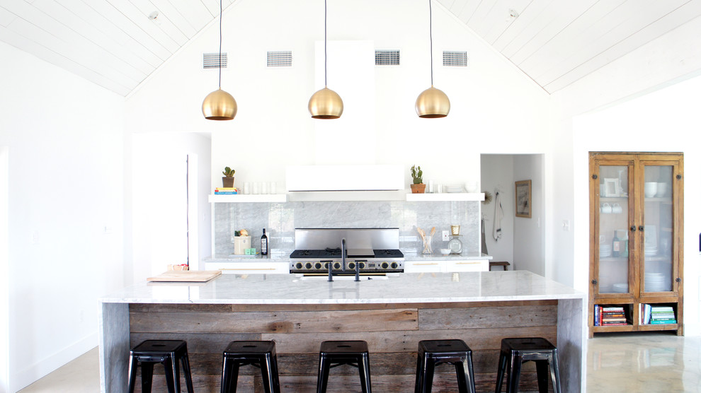 Trendy galley open concept kitchen photo in Austin with gray backsplash and an island