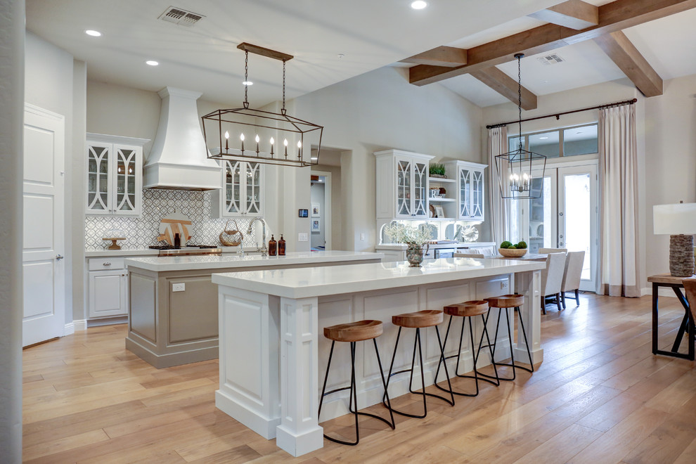 Photo of an expansive country kitchen in Phoenix with glass-front cabinets, white cabinets, quartz worktops and multiple islands.