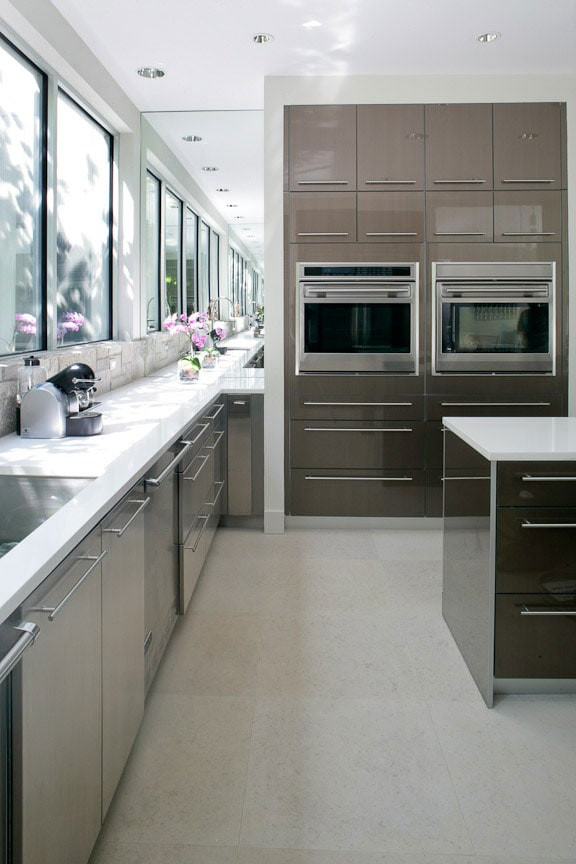This is an example of a medium sized farmhouse galley enclosed kitchen in New York with a submerged sink, stainless steel appliances and an island.