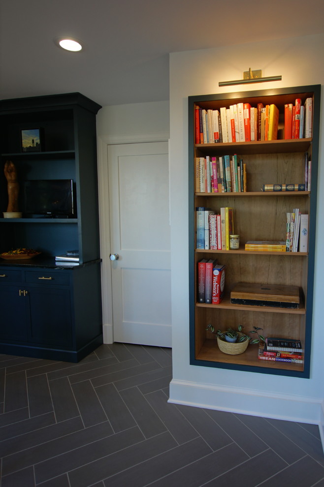 Medium sized traditional l-shaped kitchen pantry in DC Metro with a belfast sink, flat-panel cabinets, grey cabinets, soapstone worktops, stainless steel appliances, porcelain flooring and an island.