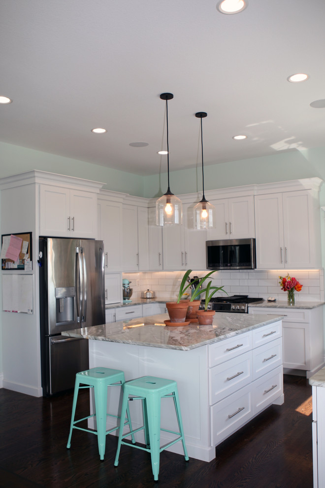 Example of a large cottage u-shaped brown floor eat-in kitchen design in Other with a farmhouse sink, shaker cabinets, white cabinets, quartzite countertops, white backsplash, an island, green countertops and stainless steel appliances