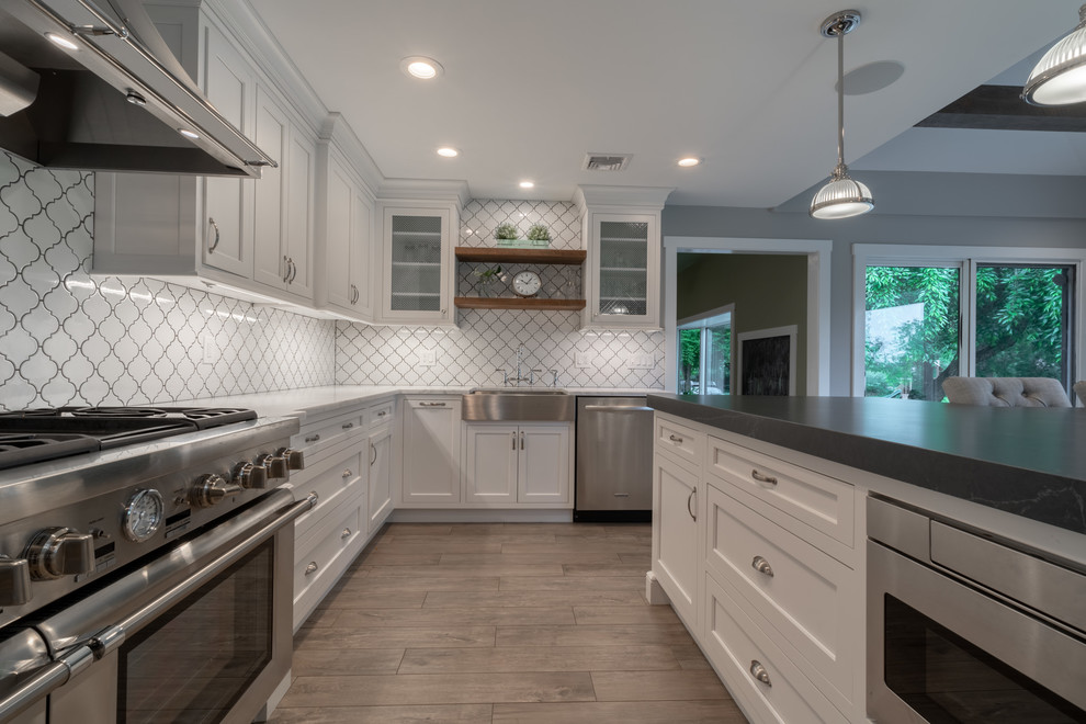 Inspiration for a huge modern medium tone wood floor and gray floor kitchen remodel in Other with a farmhouse sink, shaker cabinets, white cabinets, marble countertops, white backsplash, porcelain backsplash, stainless steel appliances, an island and white countertops