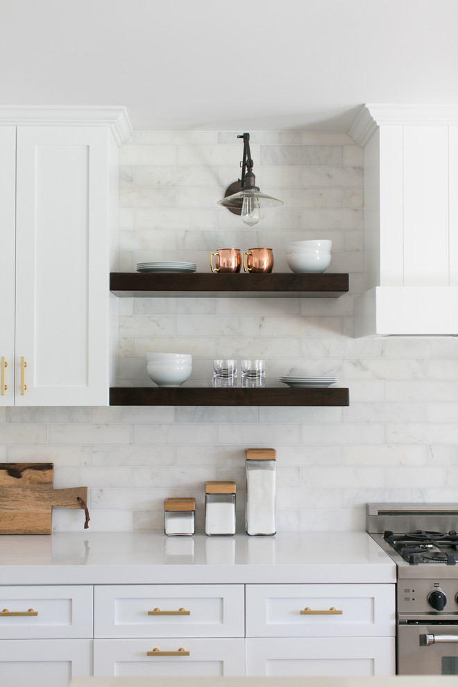 Eat-in kitchen - mid-sized country medium tone wood floor eat-in kitchen idea in Orange County with shaker cabinets, white cabinets, white backsplash, subway tile backsplash, stainless steel appliances and an island