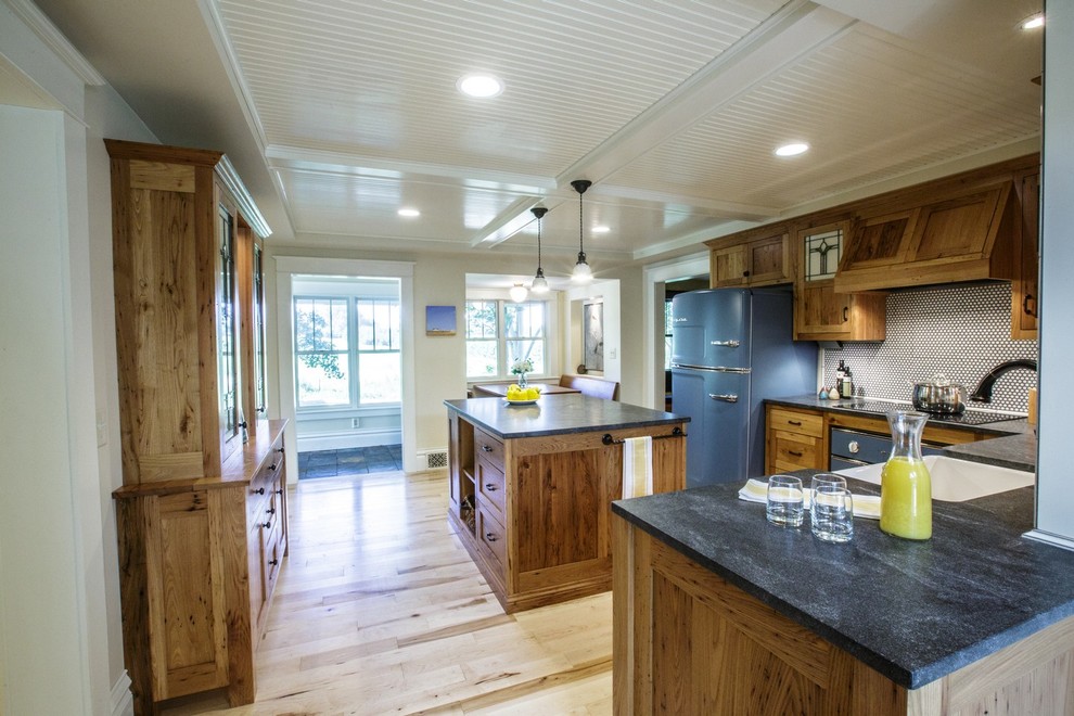 Example of a country kitchen design in Other with a farmhouse sink, medium tone wood cabinets, granite countertops and colored appliances