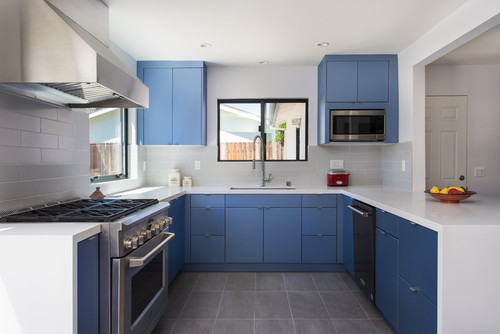 Cabinet color trends with bold blue kitchen cabinets, minimalist design, and sleek stainless steel appliances.