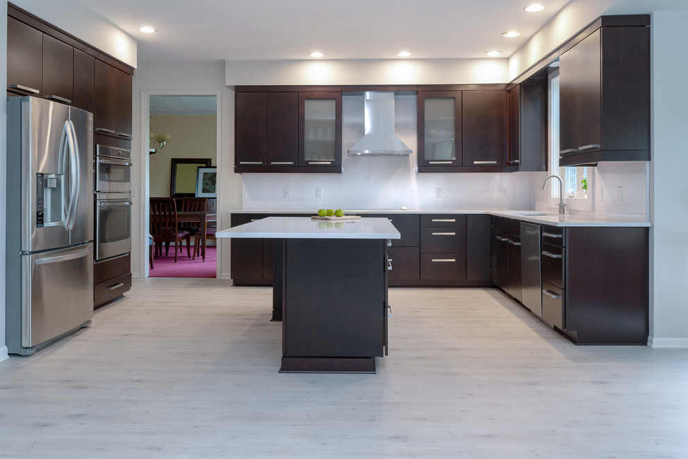 Example of a mid-sized minimalist l-shaped vinyl floor and multicolored floor eat-in kitchen design in Other with an undermount sink, flat-panel cabinets, dark wood cabinets, quartz countertops, white backsplash, stainless steel appliances, an island and white countertops