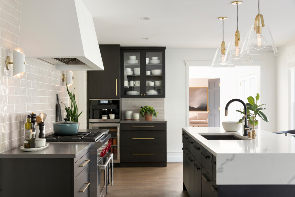 Inspiration for a large transitional medium tone wood floor and brown floor kitchen remodel in Minneapolis with a single-bowl sink, flat-panel cabinets, dark wood cabinets, quartz countertops, ceramic backsplash, paneled appliances and two islands