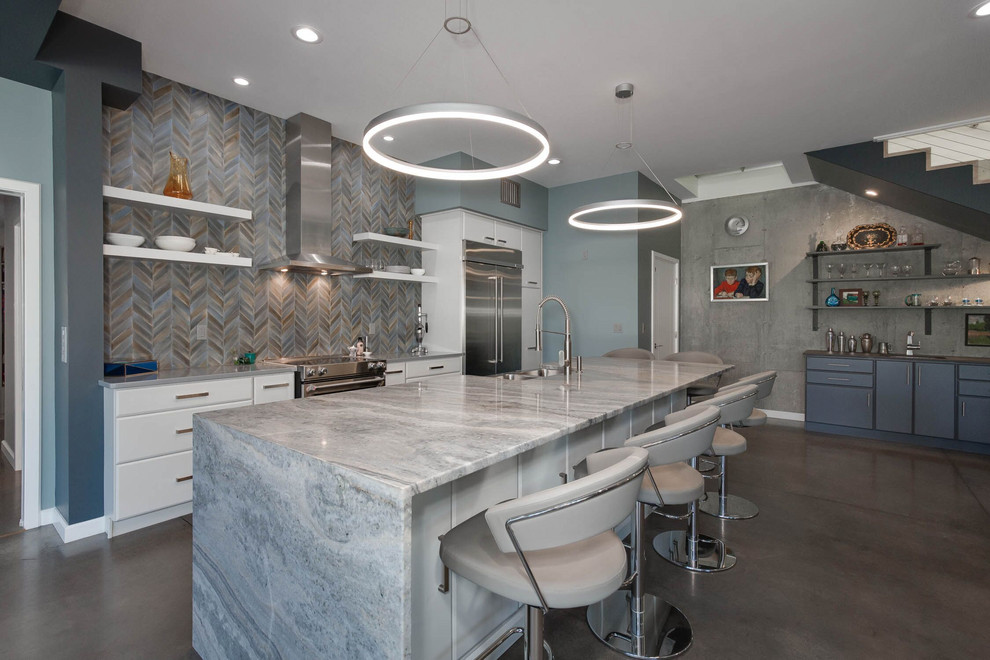 Mid-sized urban galley concrete floor and gray floor open concept kitchen photo in Providence with a farmhouse sink, flat-panel cabinets, white cabinets, quartzite countertops, multicolored backsplash, porcelain backsplash, stainless steel appliances, an island and gray countertops