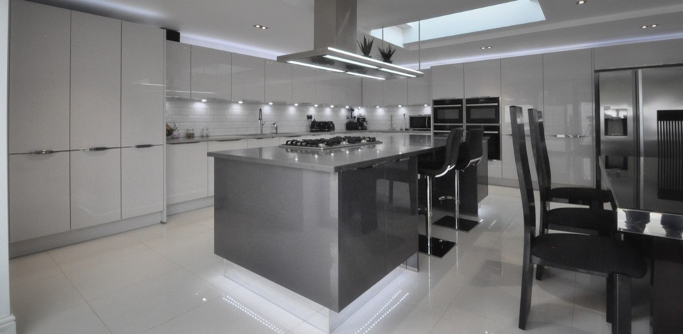 This is an example of a contemporary kitchen in Buckinghamshire with a submerged sink, quartz worktops, porcelain flooring and an island.