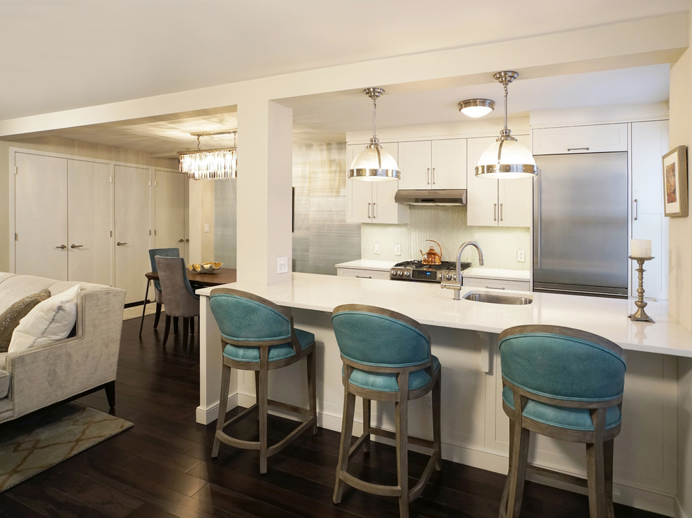 Example of a small minimalist galley dark wood floor eat-in kitchen design in New York with an undermount sink, shaker cabinets, white cabinets, quartzite countertops, green backsplash, glass tile backsplash, stainless steel appliances and an island