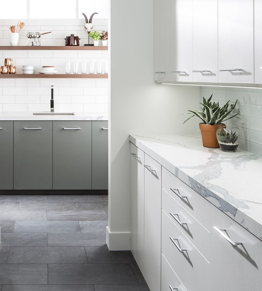 Inspiration for a mid-sized modern u-shaped slate floor kitchen remodel in Grand Rapids with a single-bowl sink, flat-panel cabinets, white cabinets, quartzite countertops, white backsplash, subway tile backsplash and stainless steel appliances