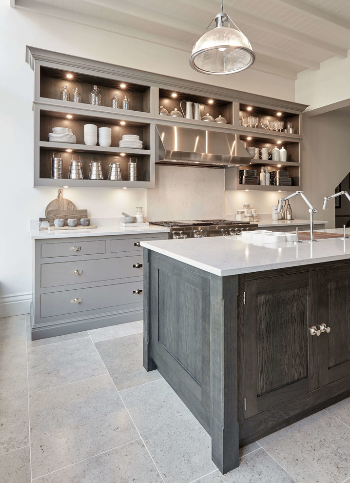 Photo of a medium sized urban u-shaped kitchen in London with an integrated sink, engineered stone countertops, white splashback, stainless steel appliances, an island, beige floors and white worktops.