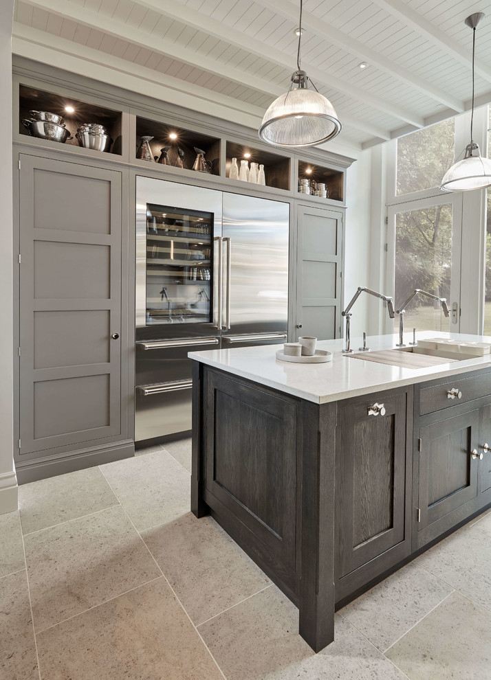 Design ideas for a medium sized urban u-shaped kitchen in London with an integrated sink, engineered stone countertops, white splashback, stainless steel appliances, an island, beige floors and white worktops.