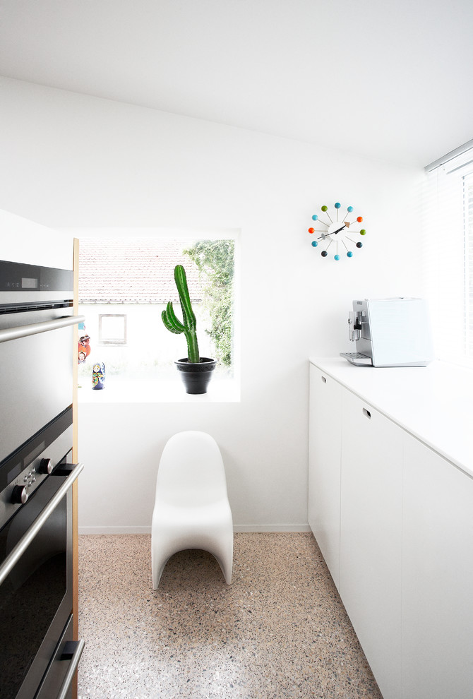 Example of a minimalist kitchen design in Other with stainless steel appliances