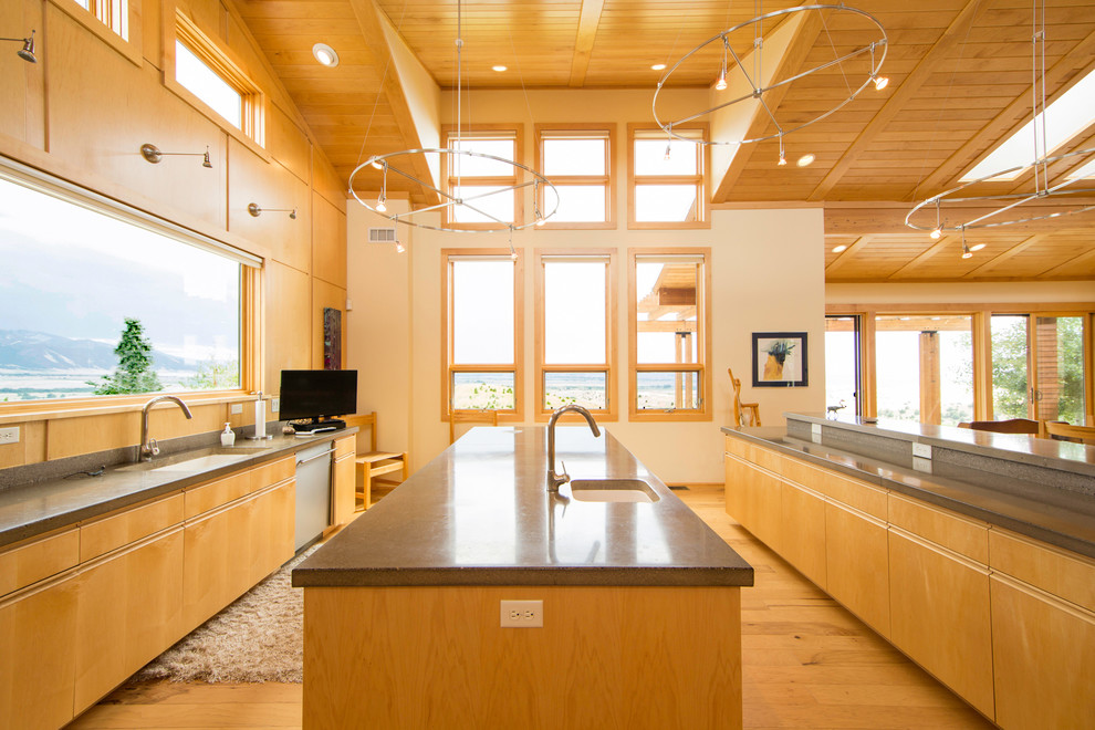 Example of a trendy light wood floor kitchen design in Other with an undermount sink, flat-panel cabinets, light wood cabinets, stainless steel appliances and two islands
