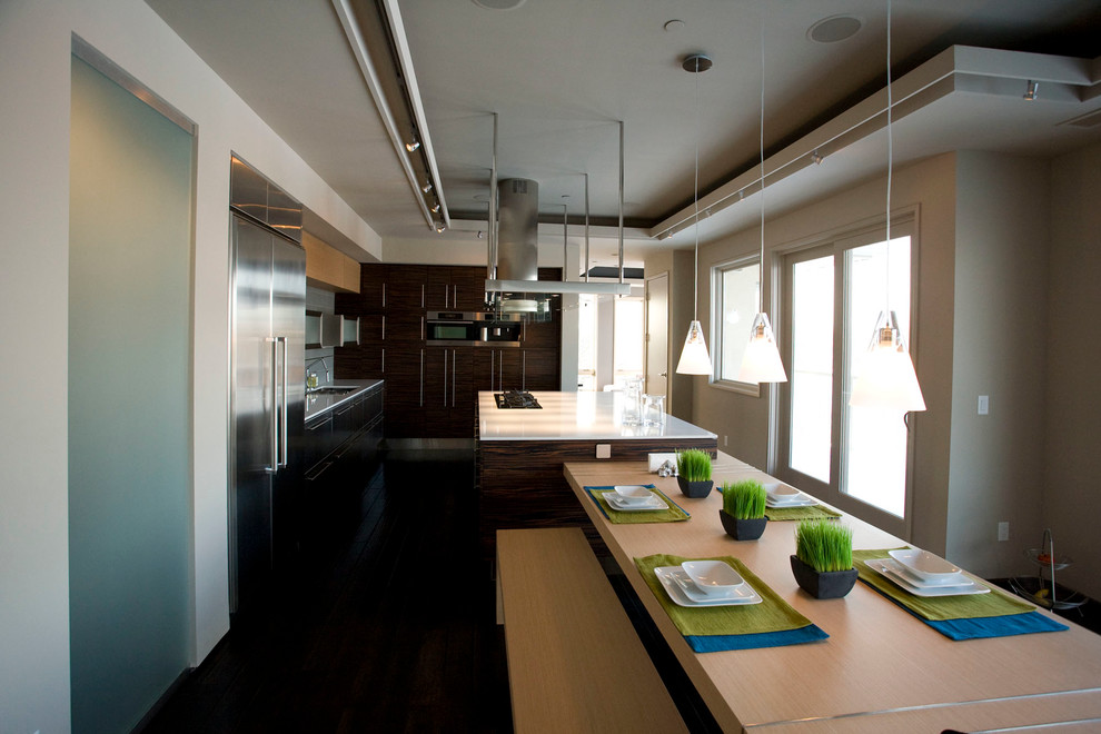 Example of a large minimalist u-shaped dark wood floor eat-in kitchen design in Minneapolis with flat-panel cabinets, light wood cabinets, gray backsplash, stainless steel appliances, an island and an undermount sink