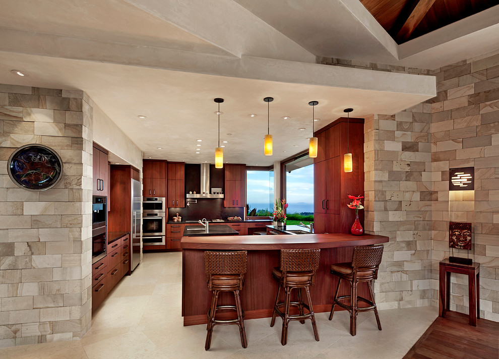 Example of a large island style u-shaped limestone floor open concept kitchen design in Santa Barbara with an undermount sink, flat-panel cabinets, dark wood cabinets, granite countertops, black backsplash, stone slab backsplash, stainless steel appliances and an island